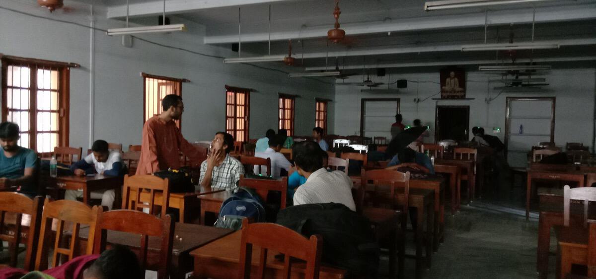Indian college students studying together at a busy college study hall
